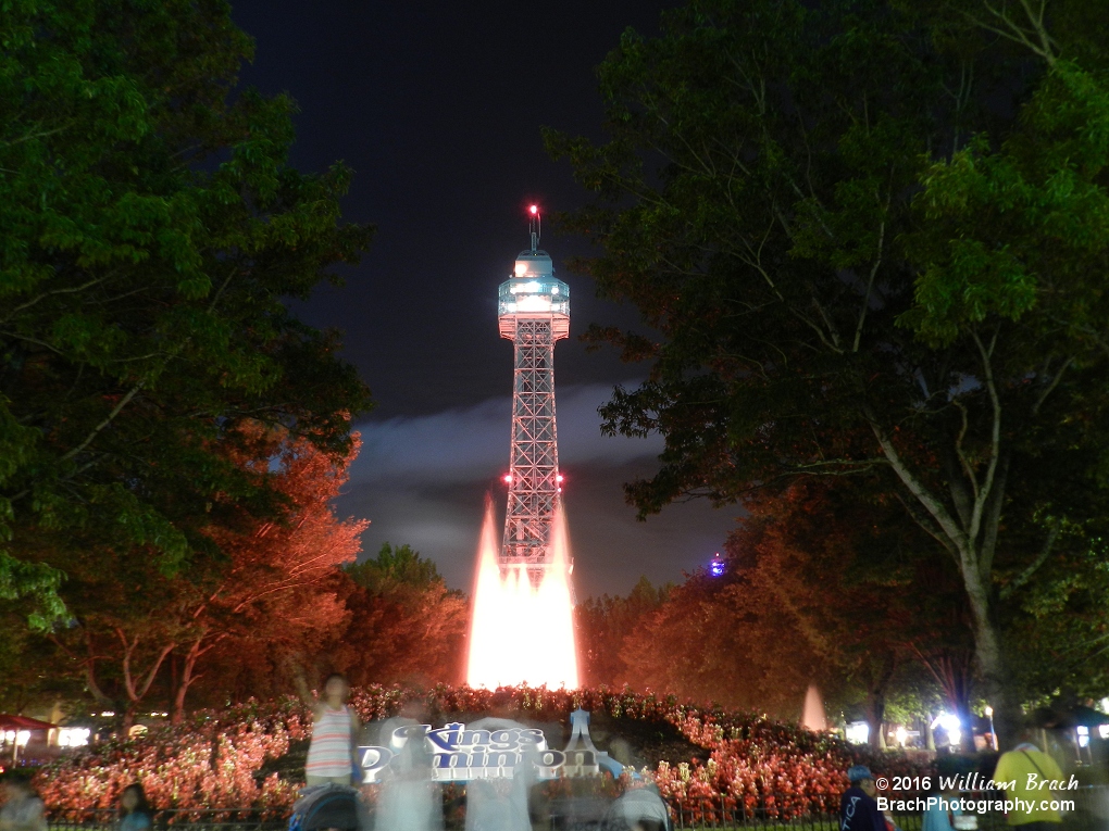 Looking at the Eiffel Tower at park close.  Beautiful in the bask of red lights isn't it?