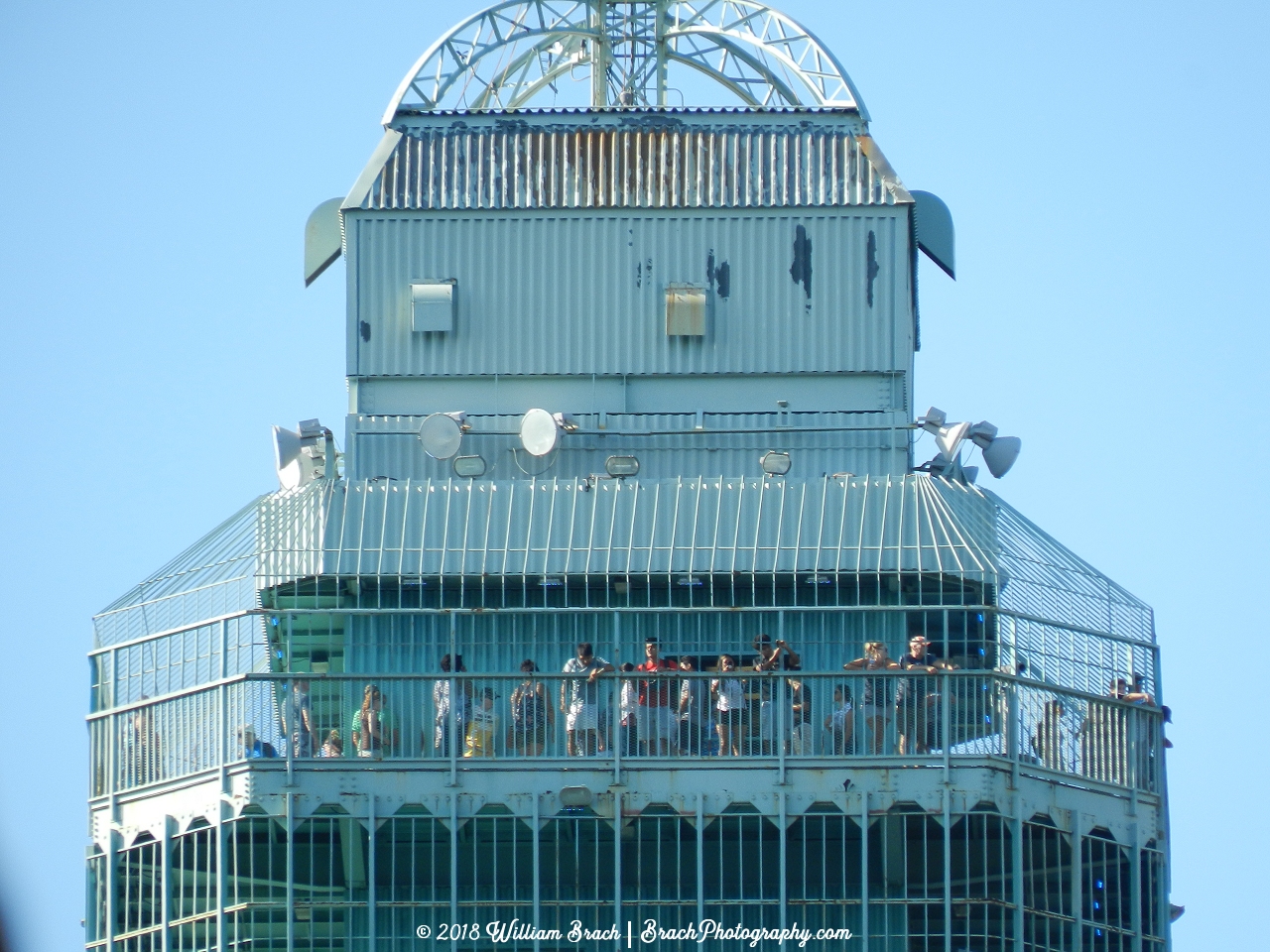 Eiffel Tower observation deck with lots of people checking out the view.