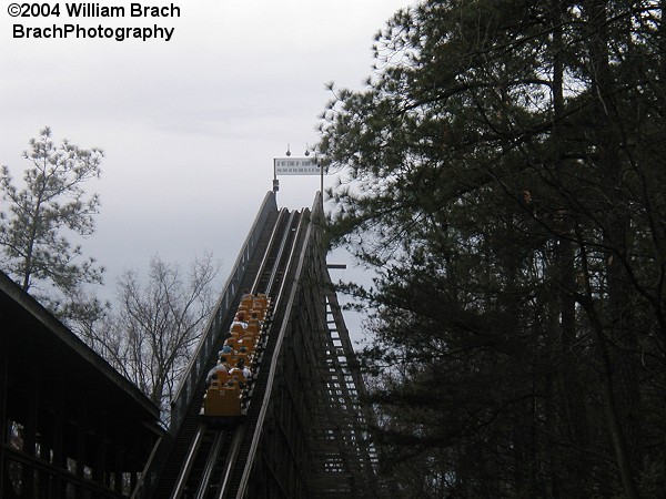 Yellow train going up the lift hill.