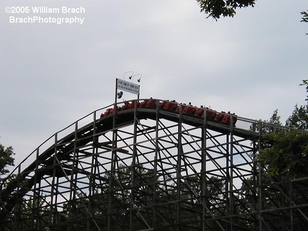 Orange train making its way up the lift hill.