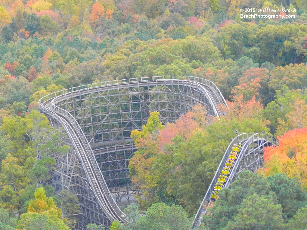 Yellow train going up the lift hill.