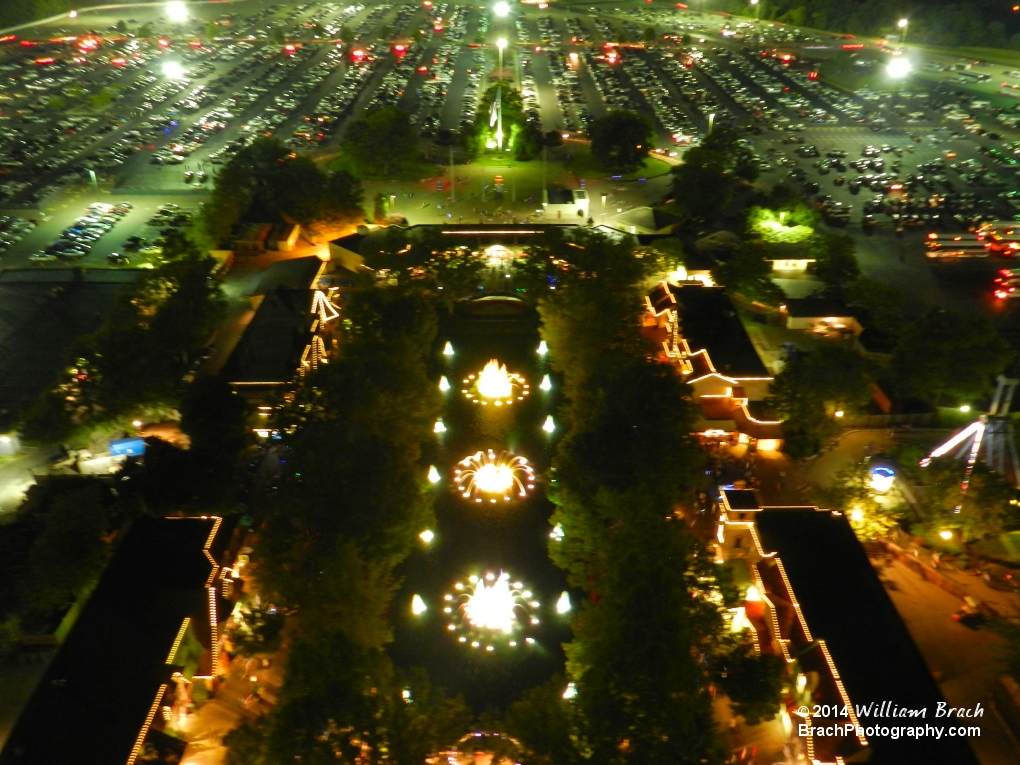 Fountain all lit up in yellow lights at night.