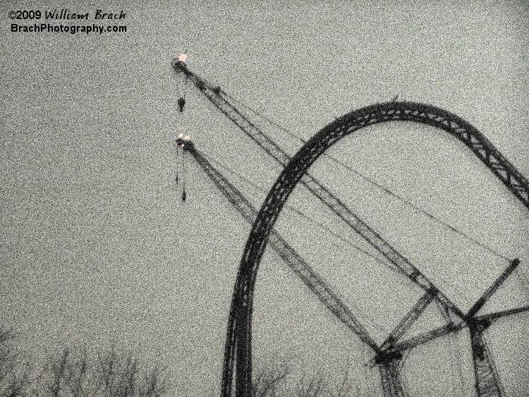 View of the top of the lift and the drop with the two cranes in the background. 