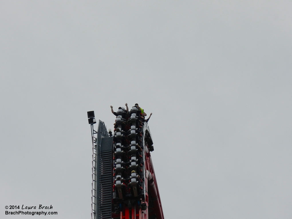 Silver train cresting the top of the lift hill.