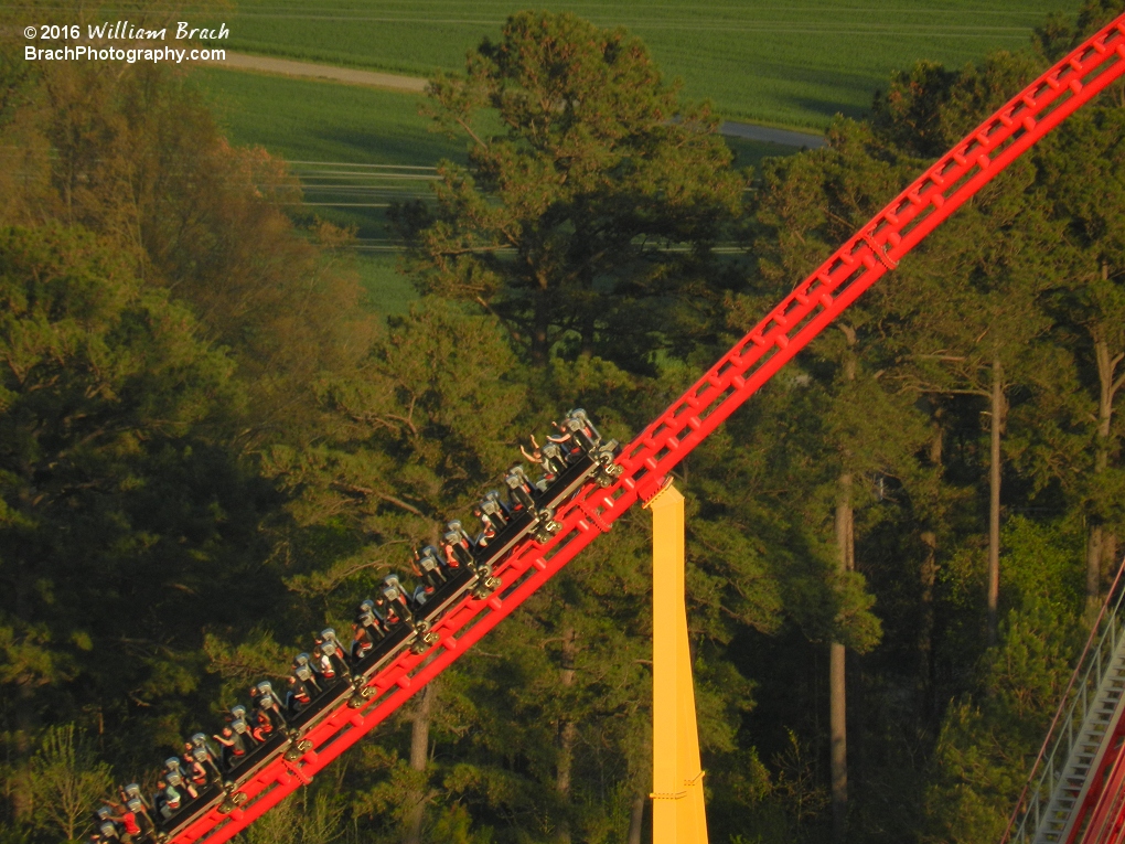 Silver train going down the second hill.