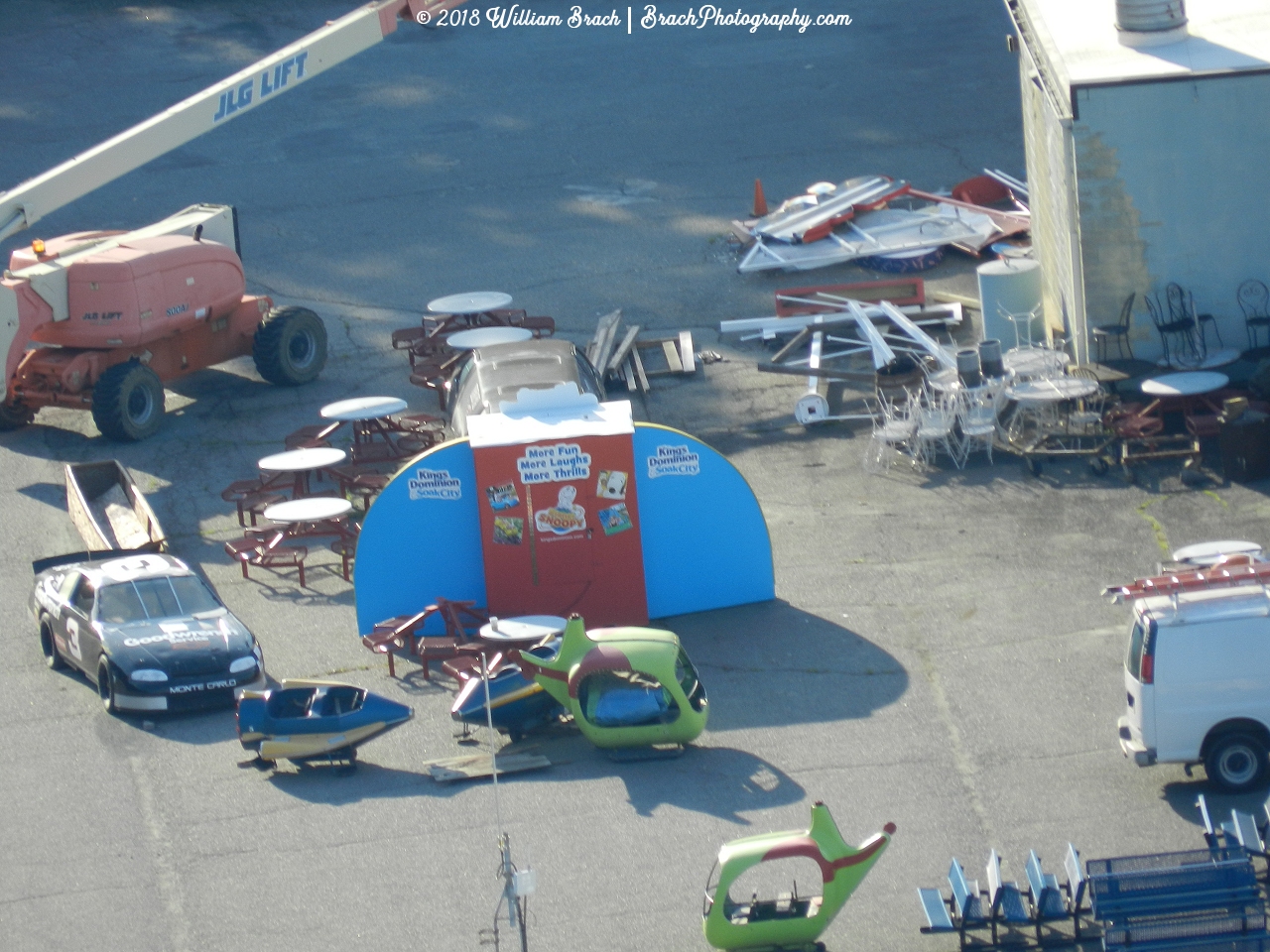 Former ride parts and broken furniture in the park's service garage area.