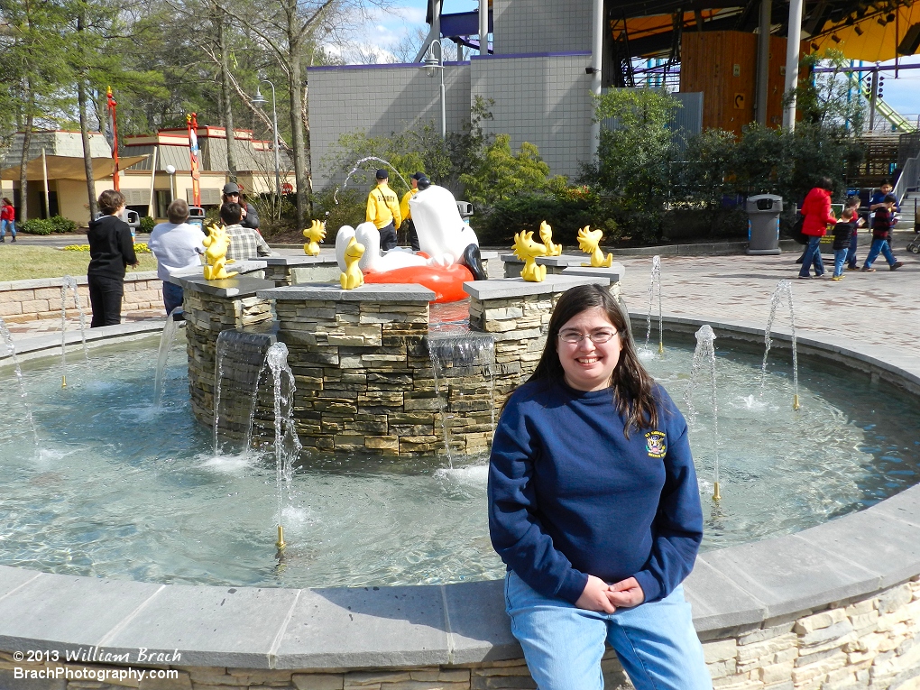 My wife posing for a smile infront of the new Snoopy fountain.