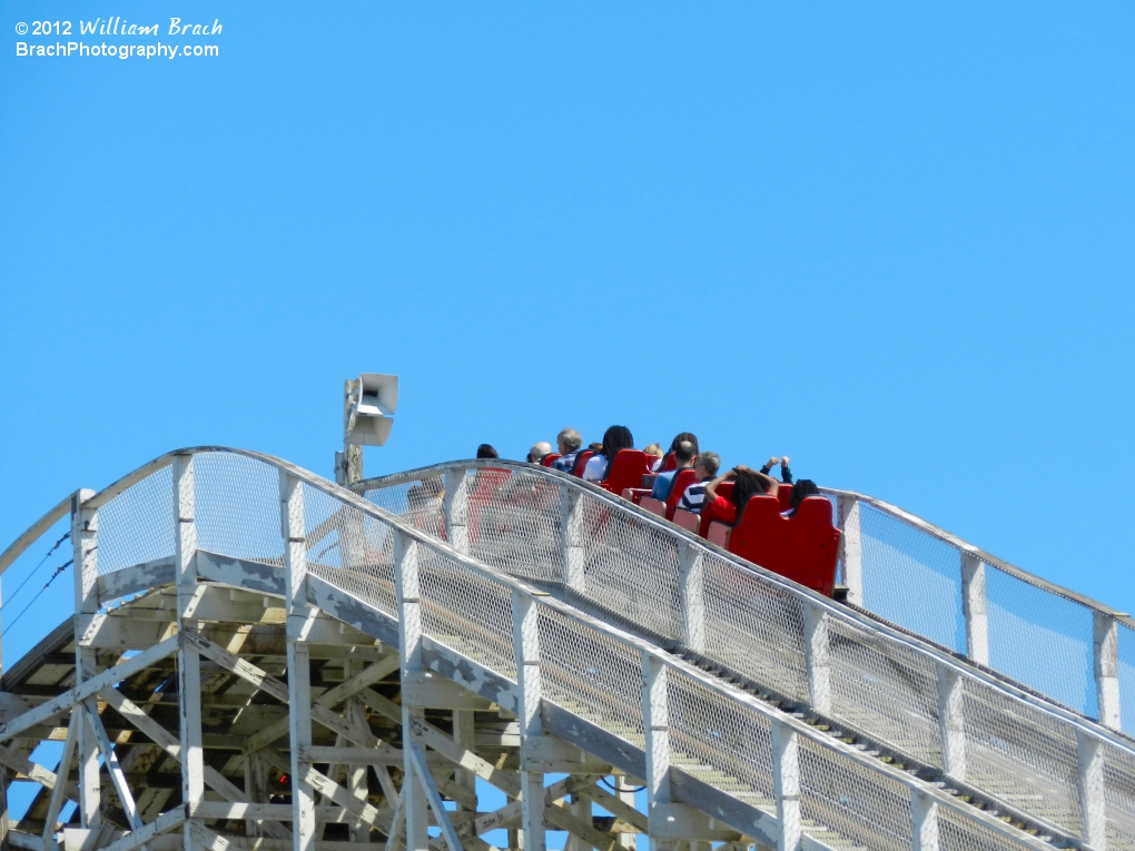 REd train on the South side of Rebel Yell crests over the lift hill.