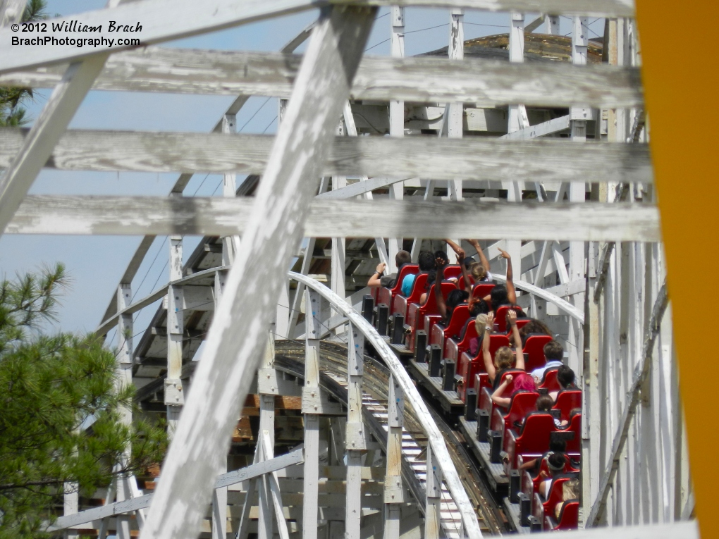 Peeking through the supports of Rebel Yell to get a glimpse of the train headed back towards the station.