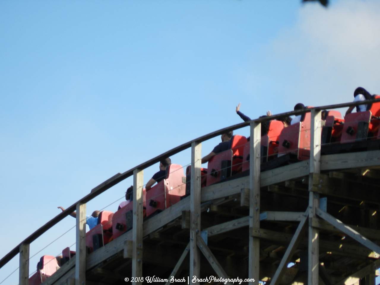 Racer 75 red train cresting the lift hill.