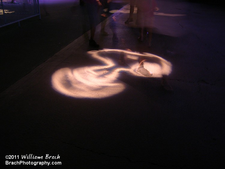 Snoopy's figure was shining on the ground near the Eiffel Tower.