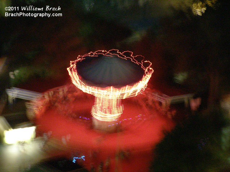 Wave Swinger in motion at night as seen from the Eiffel Tower.