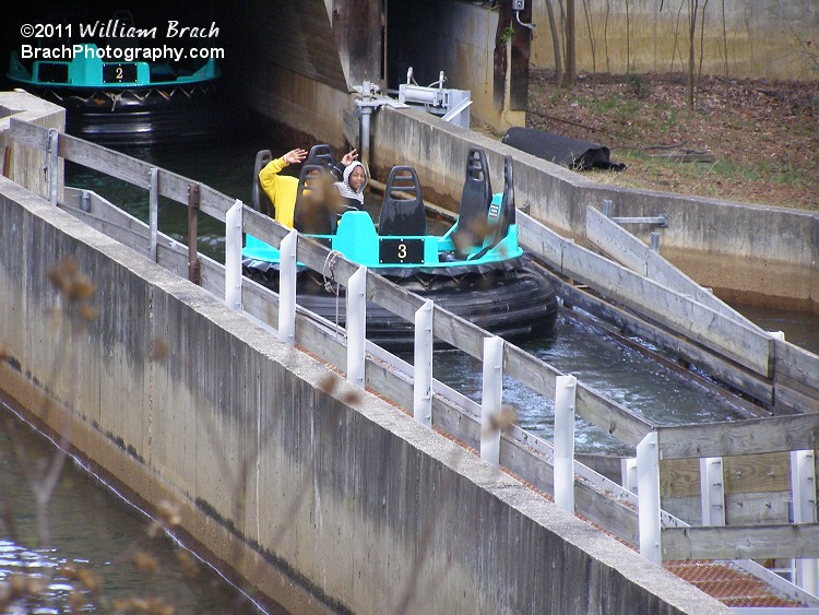 Temps only reached the mid-50's on Opening Day 2011.  People were still riding the water rides.  There we see two people waving st me.  They didn't look to be all that wet from the ride.