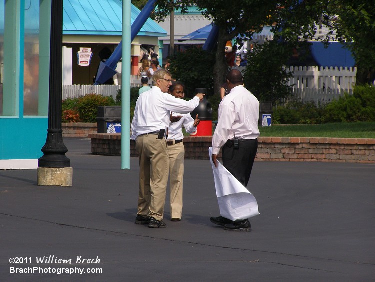 Looks like they were discussing what would be happening this winter in the park.  Look what's in that guy's hands...