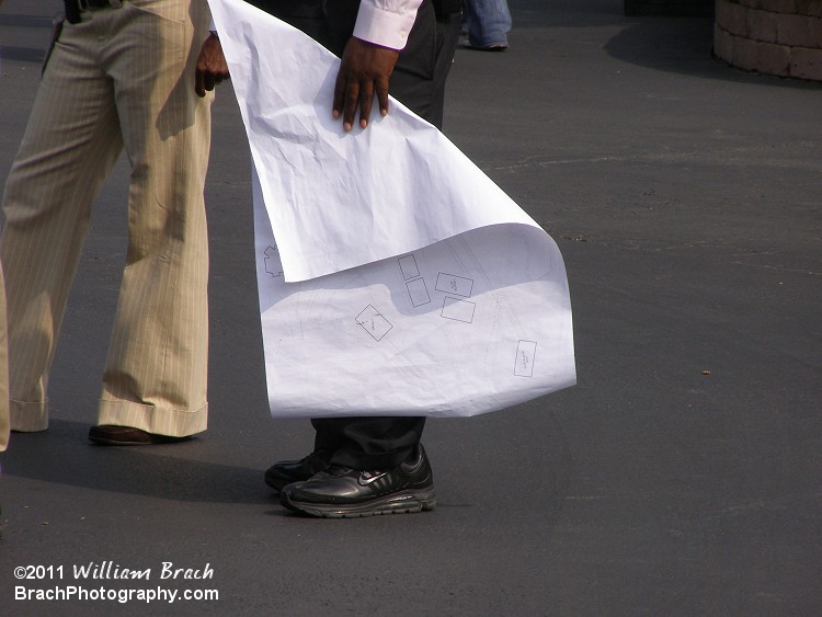 ....BLUEPRINTS!!  Sadly, this blueprint doesn't reveal anything new for 2012.  The guy was smart to fold the blueprint over while he's holding it.