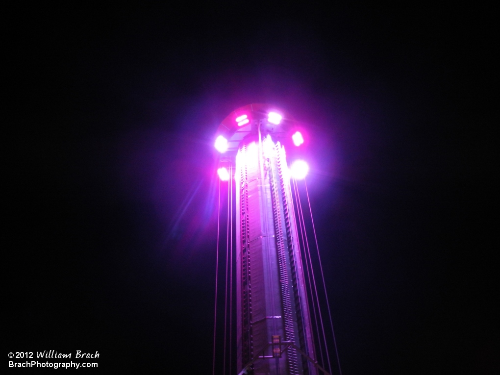 Looking up at the WindSeeker tower at night.