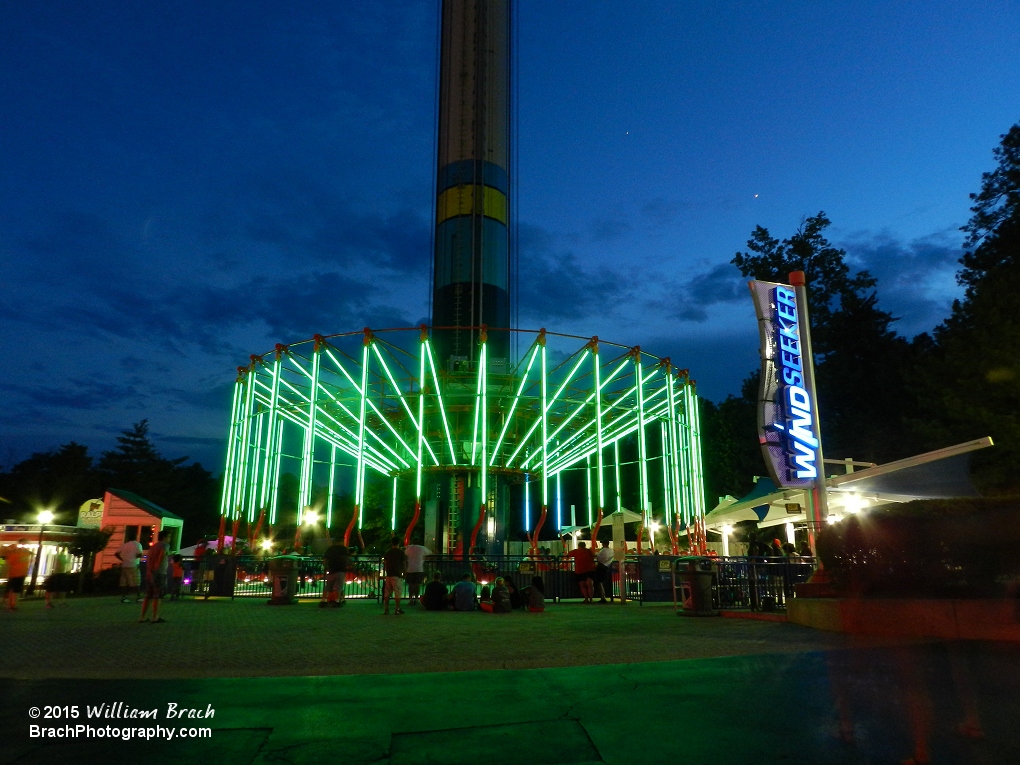 WindSeeker all lit up in green lights at night.