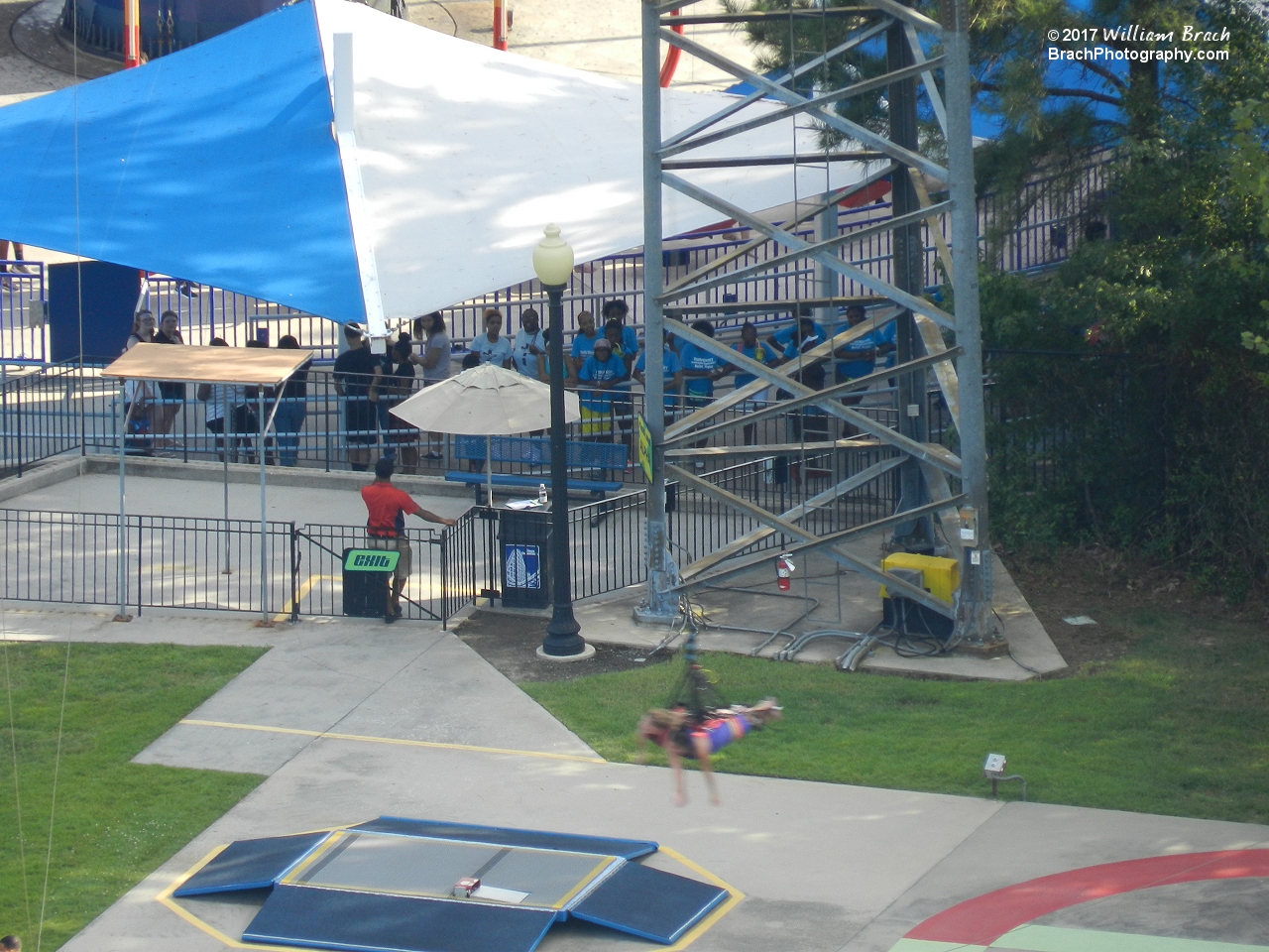 Riders rushing by the loading platform on the Xtreme Skyflyer!