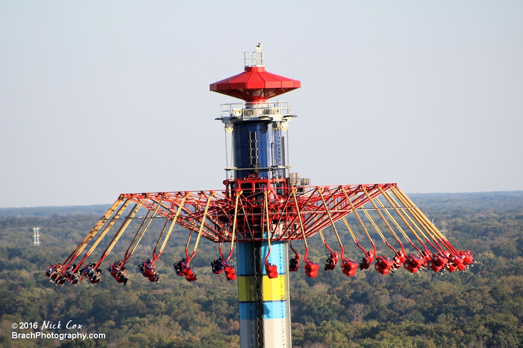 WindSeeker flying at the top of its large structure.