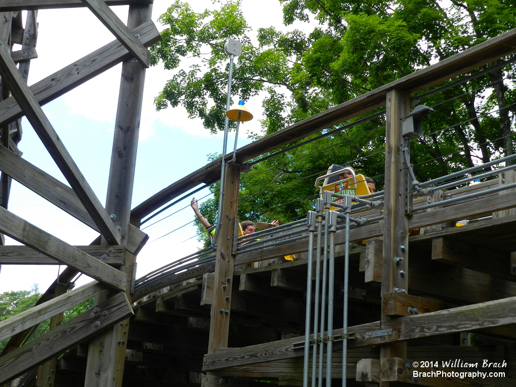 The Flying Turns yellow train on the track.