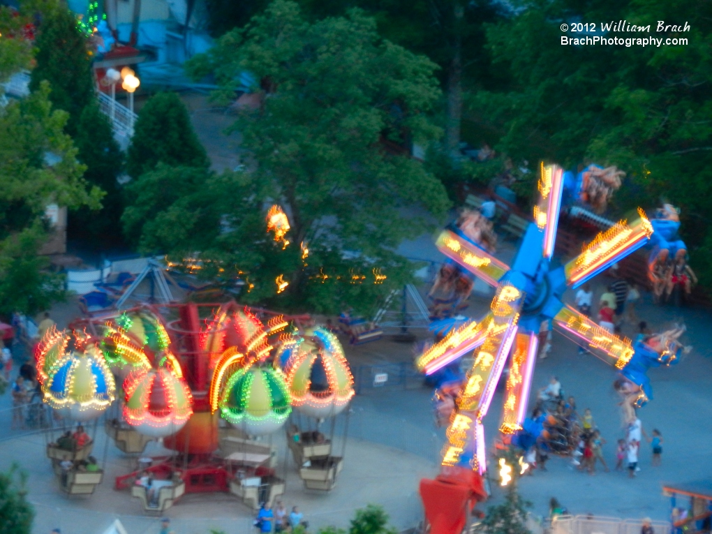 Balloon Race and Power Surge ride lights on at dusk.