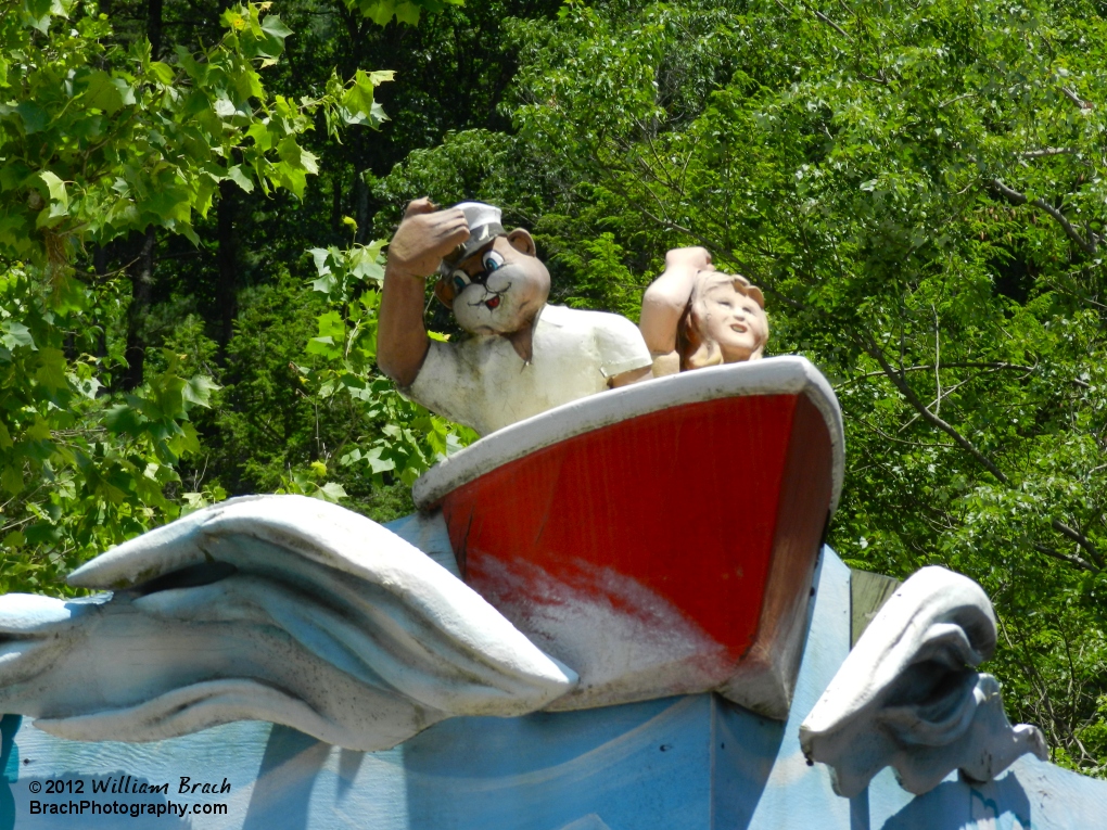 Kozmo and a friend in the boat carving on top of the ride's station building.