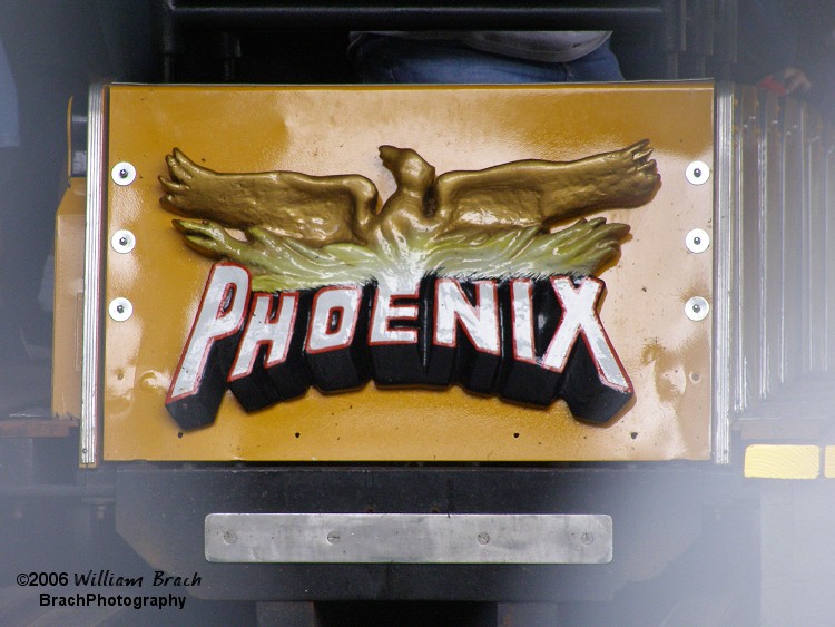 Closeup of the ride's logo seen on the front of the yellow train.