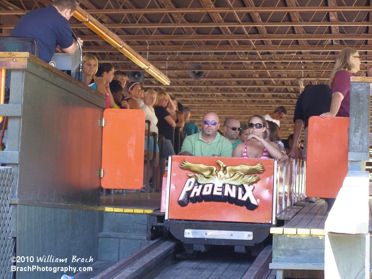  Orange train getting ready to roll out of the station.