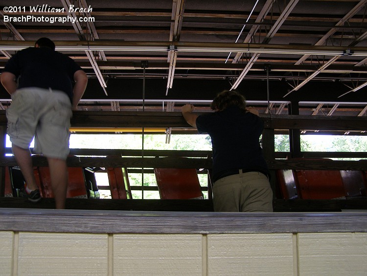 Phoenix Ride Operators are pushing the orange train that's been in the holding track to line up with the station track back to allow the train to be put into service.  Crowds at Knoebels were moderate in size and the second train on Phoenix was needed that day.