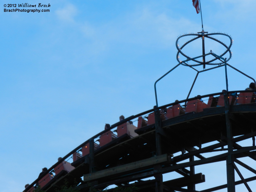 Orange train making its way down the first droip from the lift hill.