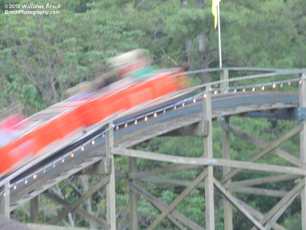 Orange train flying over the hills.