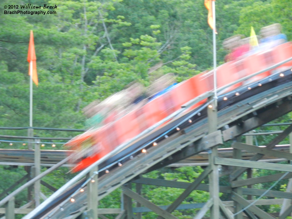 Orange Phoenix train flying down the hill.