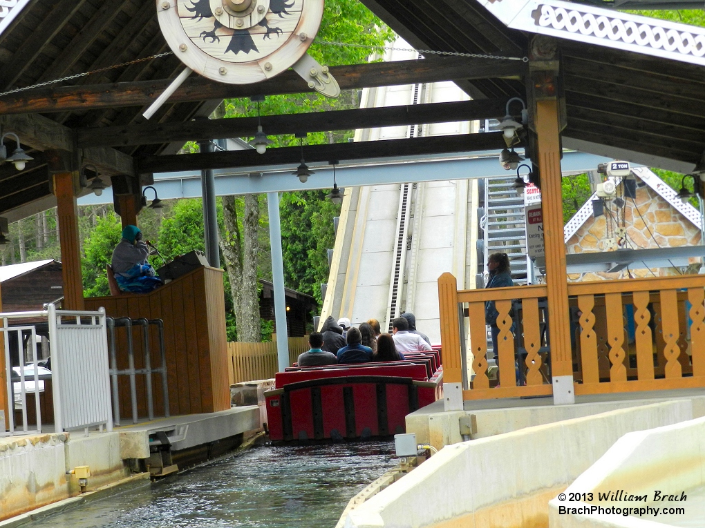 Red boat leaving the station and headed up the lift hill.