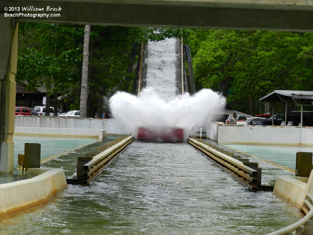 Red boat hitting the water with a huge splash!