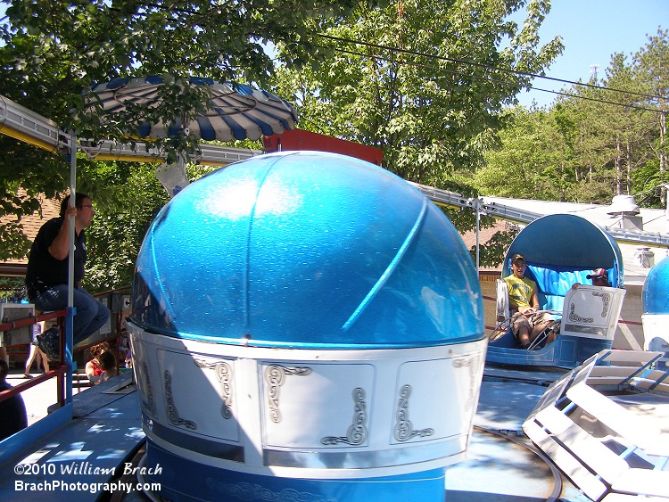 Tilt-A-Whirl riders enjoying the thril of being tossed around in their coffin cars.