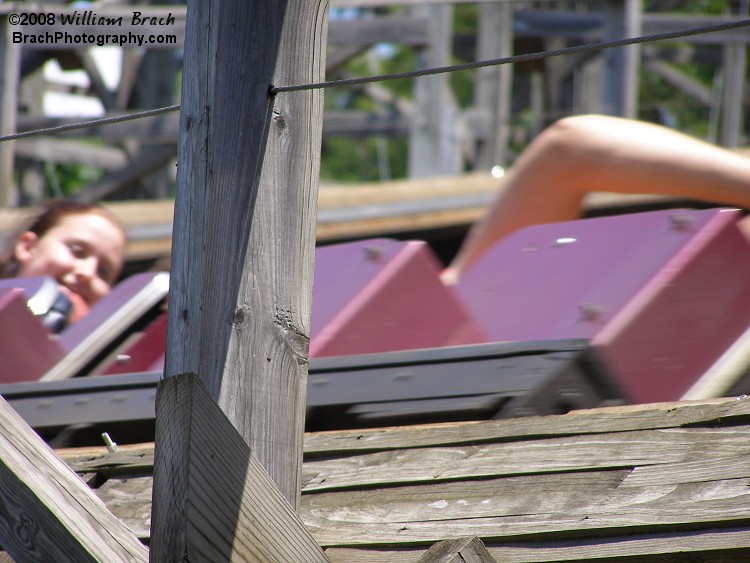 Detail look of the wood work on Twister.  Purple train is rushing by.