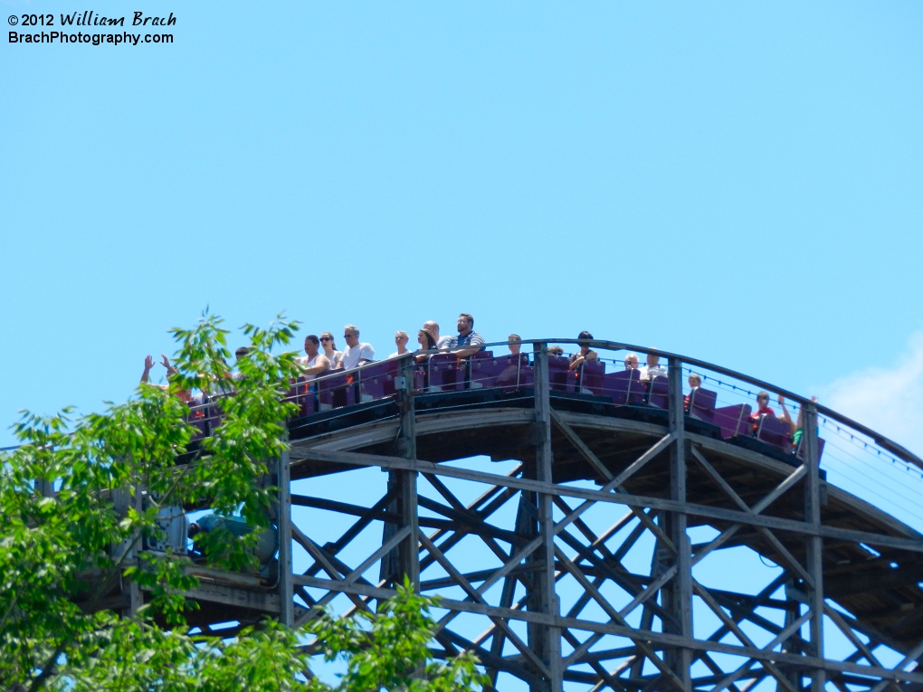 Purple train cresting the top of the second lift hill.