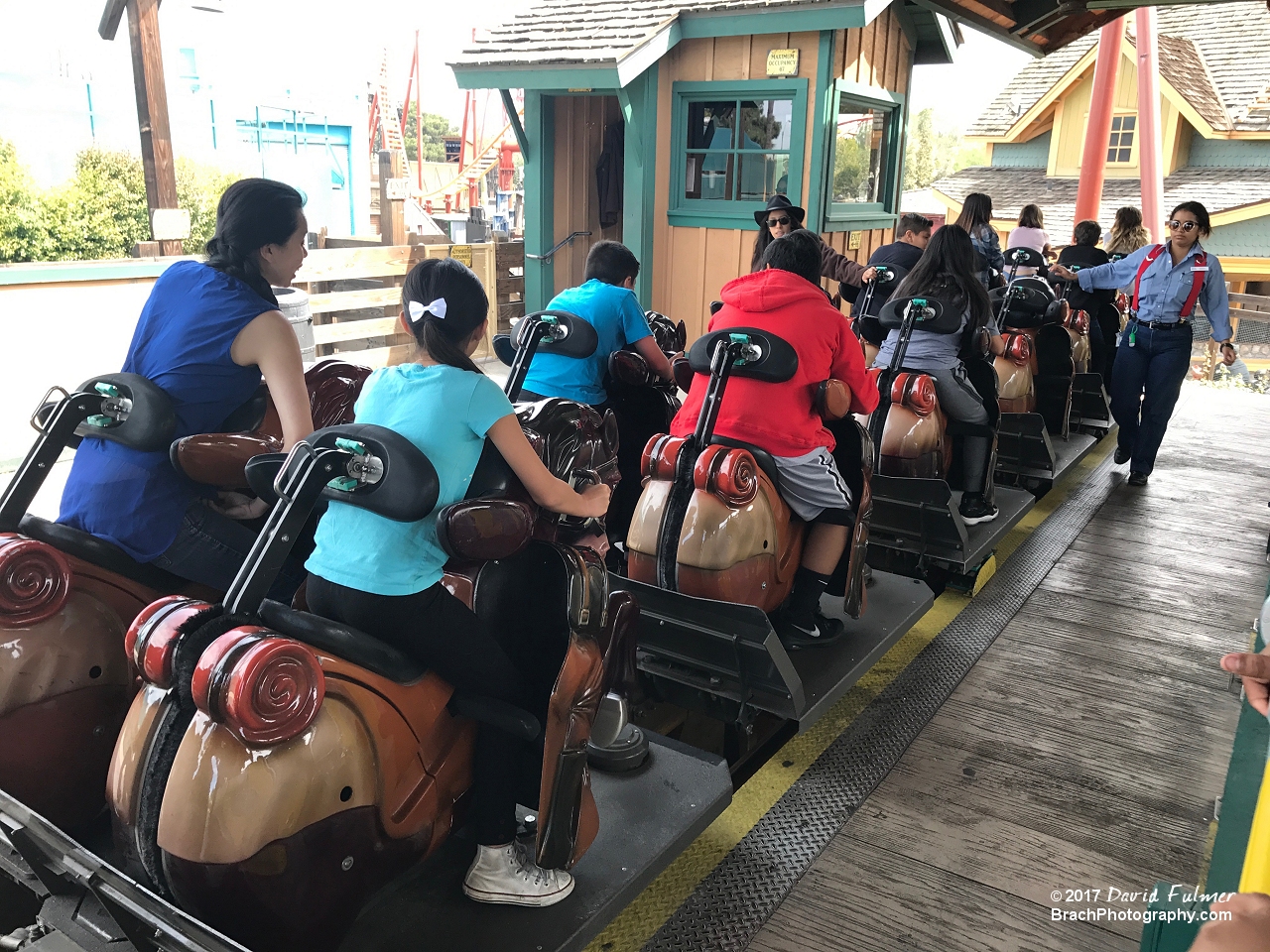 Pony Express ride operators checking the restraints.