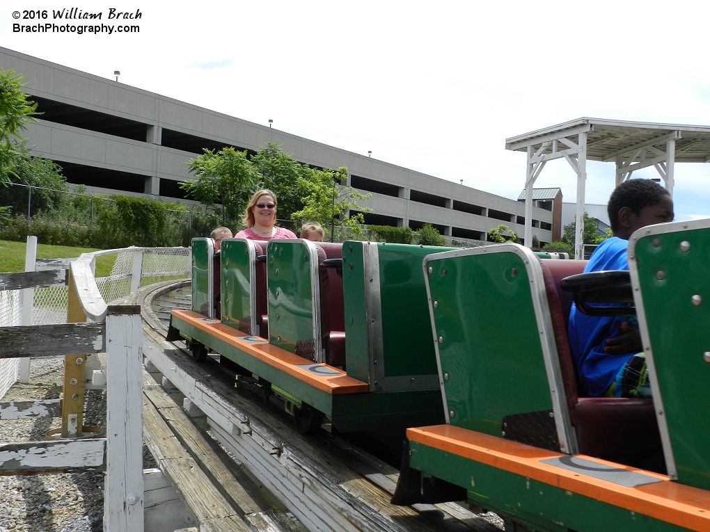 Skyliner's train about to enter the lift hill with very excited riders.