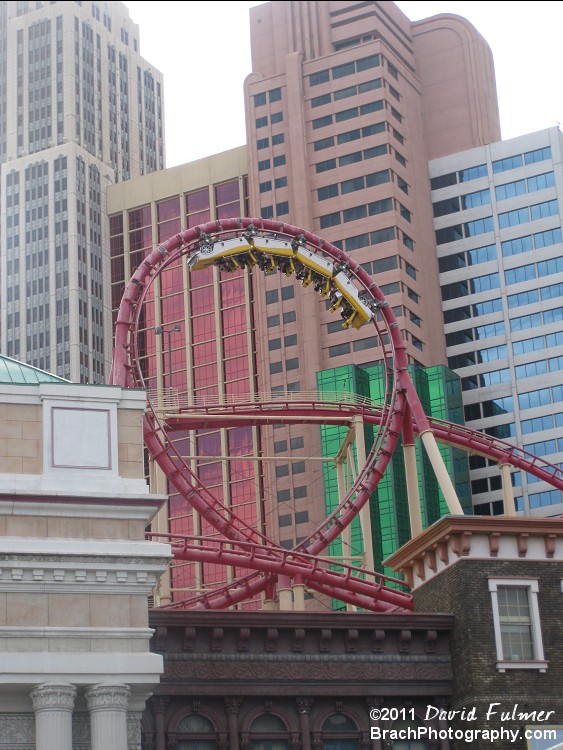 Picture freeze of train hanging upside down in the loop.  There are only two inversions.