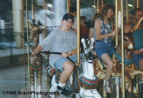 Me (your webmater) at age sixteen riding the Carousel by the Lake.  *yeehaw!* Whip the horste to make him go faster!  *sigh*  I miss that park.