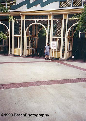 Your webmaster in June 1998 visiting the then-closed Opryland USA.  This was the main entry gates to the park.  The sign infront of the Ticket Booth reads: AREA CLOSED. 