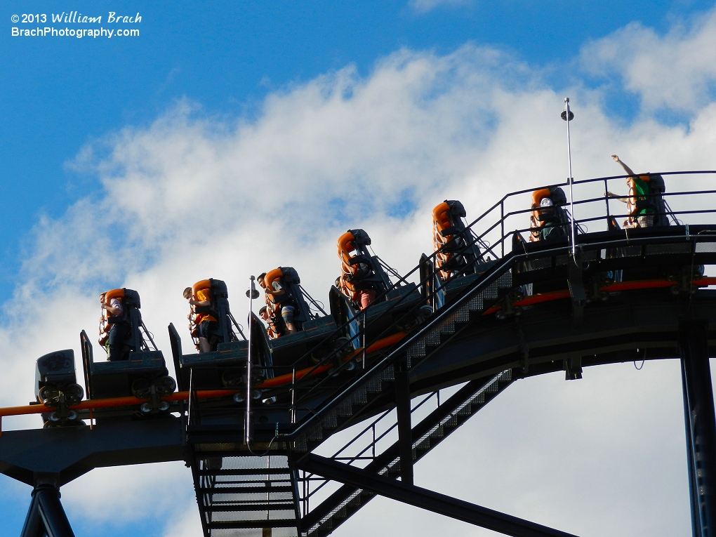 Train cresting the lift hill and about to begin the ride.