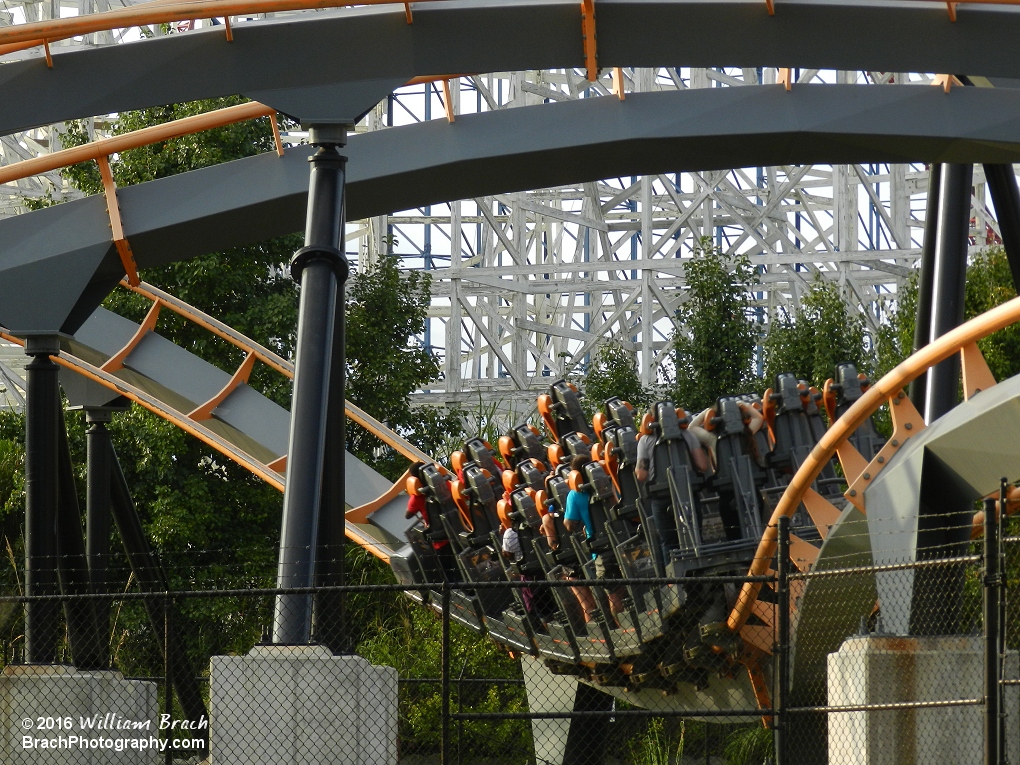 Apocalypse train running through a dip before another inversion.