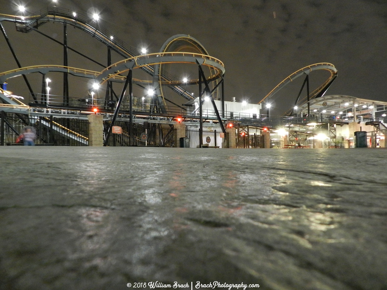 Apocalypse ride area at night.  Pay close attention to the vertical loop.  The train is rushing through the loop.