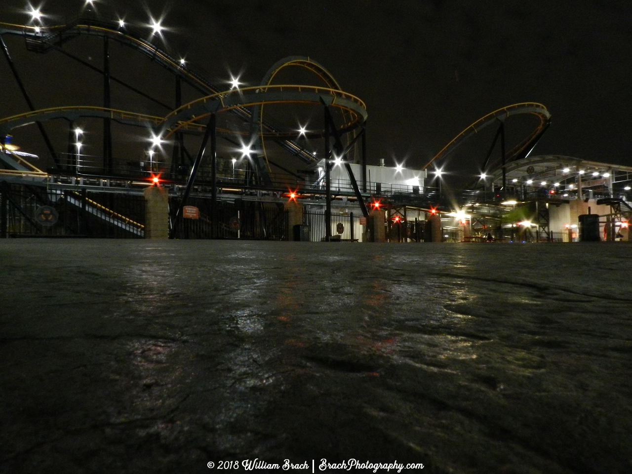 Apocalypse ride area at night with the red warning lights lit up.