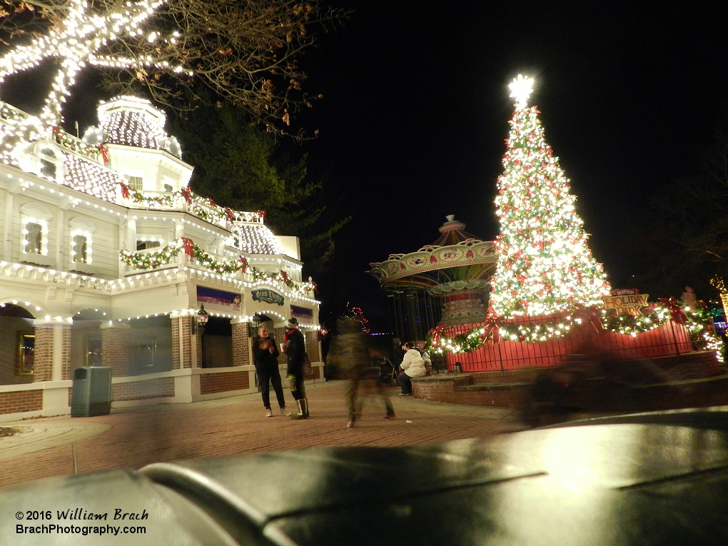 The tree and theater lit up in lights.