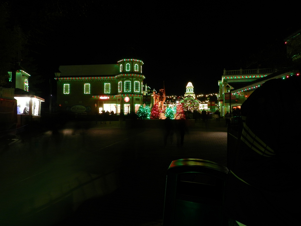 Looking towards the front gate lit up at night.