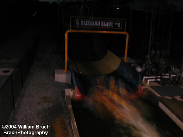 A raft is passing through the finish line at night.