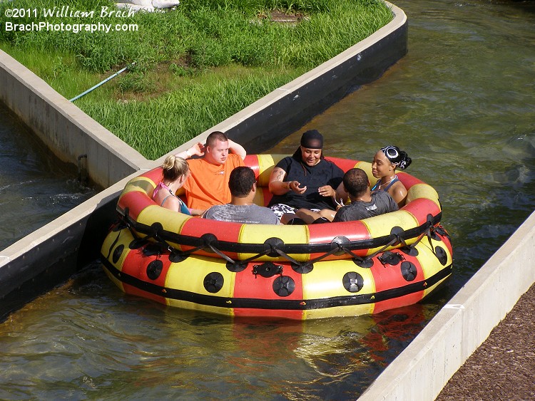 Raft drifting back to the station with happy and semi cooled off riders.